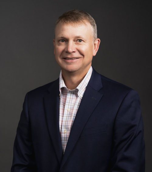 Jeff Rutledge, attorney at Adams, Hemingway, Wilson & Rutledge, LLC, wearing a plaid dress shirt under a navy blue suit jacket