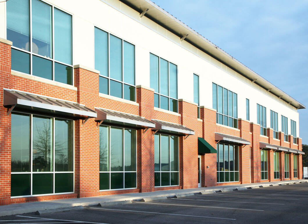 Parking lot next to modern strip mall windows